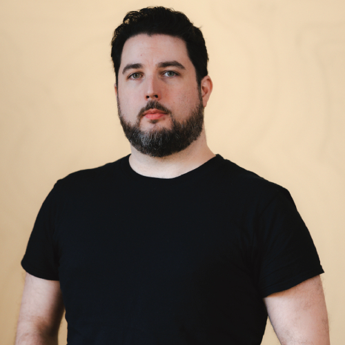 An upper-body photograph of Virgil Watkins with his hands in his pockets.