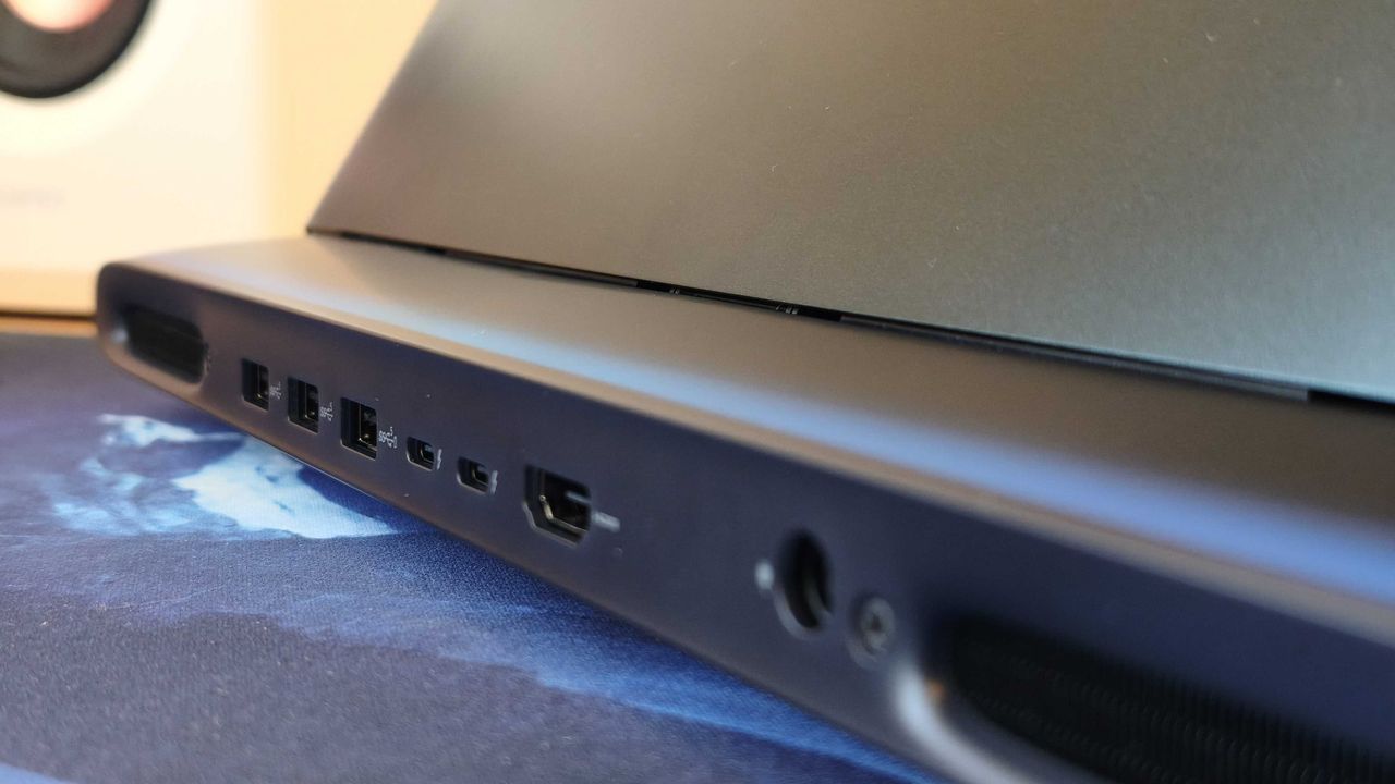An Alienware 16 Area-51 laptop on a wooden desk
