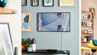 The best NFT displays are represented by a photo of Samsung's The Frame on a living room wall