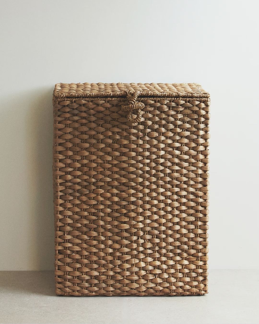 A series of sculptural rattan decorative items, including place mats, cake stands, laundry baskets, lights, napkin rings, and storage units.