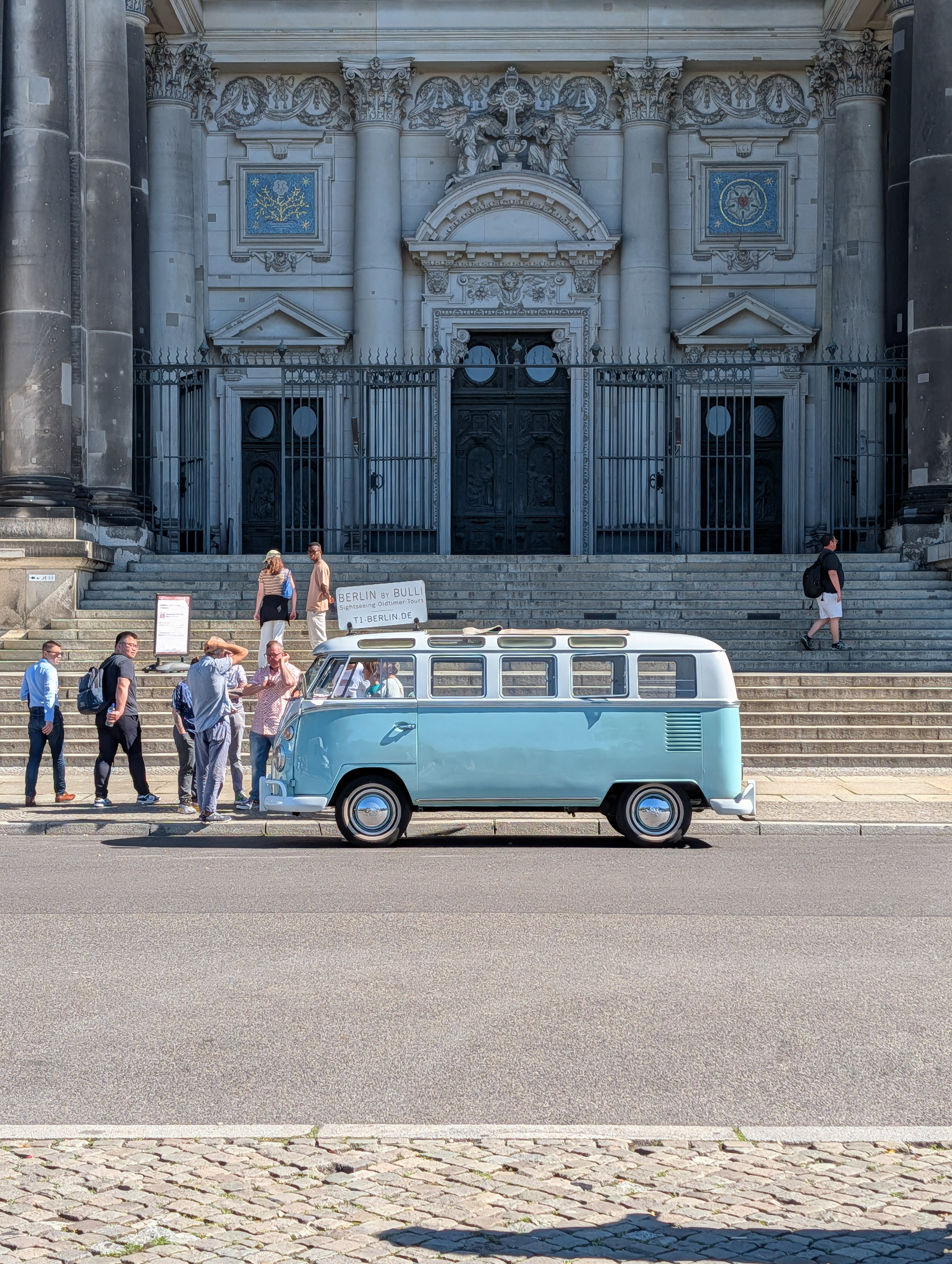 A VW camper van parked outside a large church