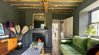 renovated living room with open fire and grey walls and ceiling, flagstones and exposed beams