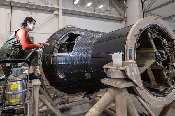 A conservator uses a vacuum to clean inside Freedom 7, the first Mercury capsule to carry a U.S. astronaut into space 60 years ago, in the Mary Baker Engen Restoration Hangar at the National Air and Space Museum&#039;s Steven F. Udvar-Hazy Center. 