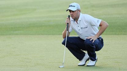Justin Thomas lines up a putt