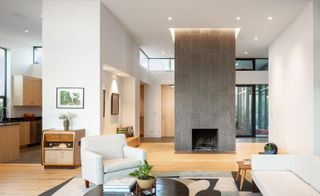 Living space focusing on fireplace at Mar Vista Residence by Tim Gorter Architect