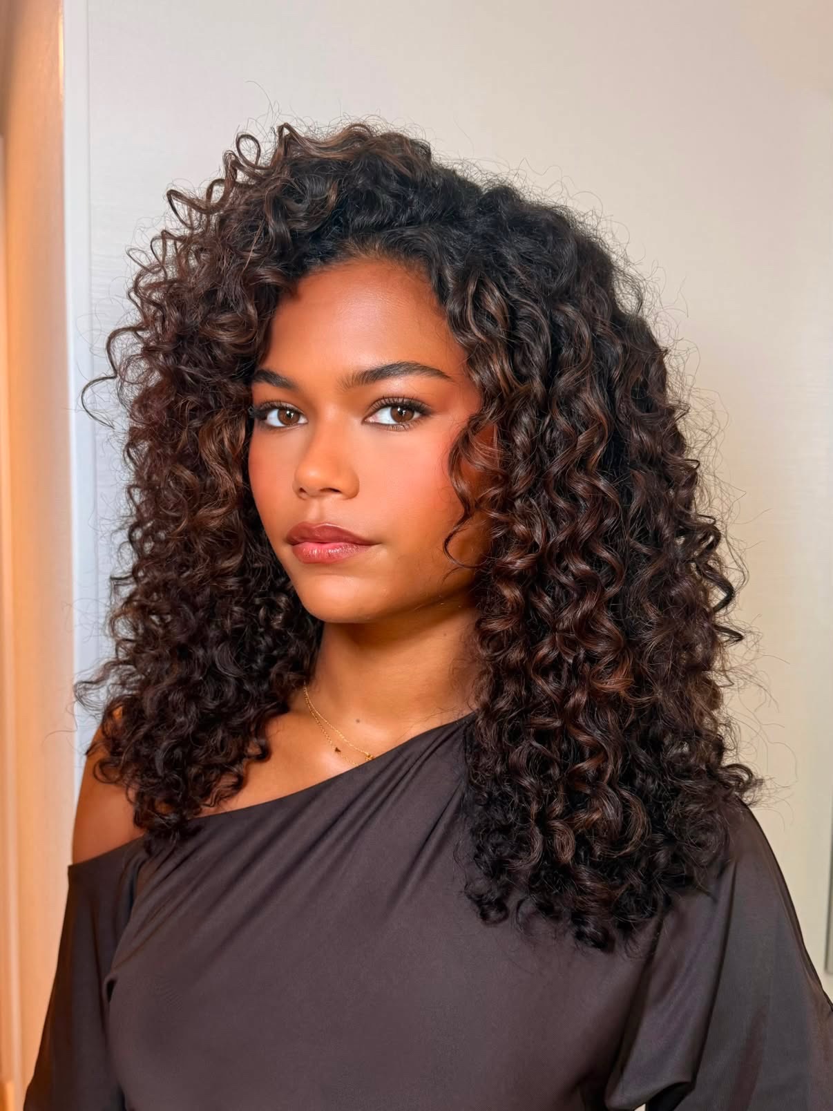 Tamara Smart with curly dark hair and highlights