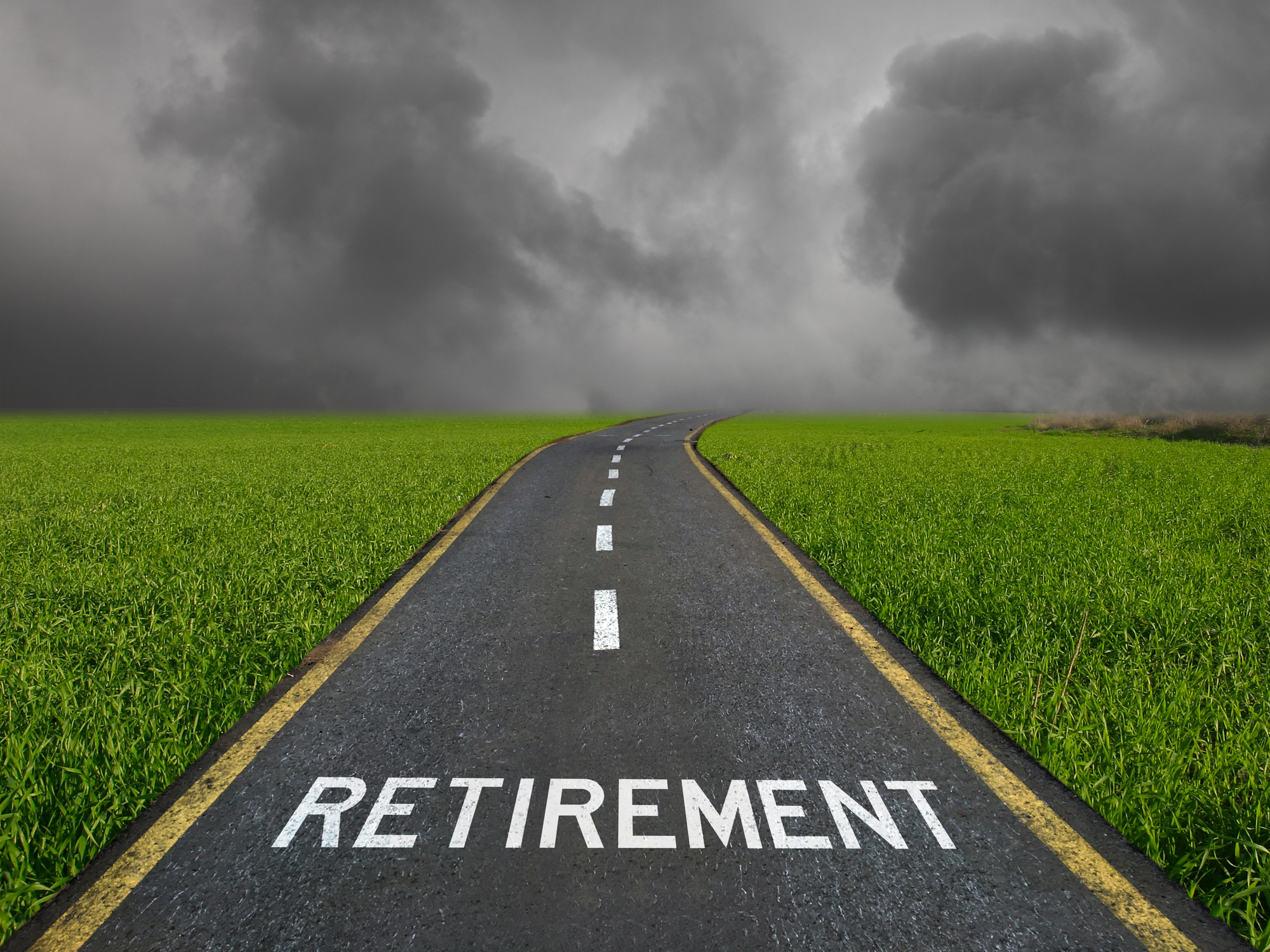 "retirement" written on a road with green grass and stormy skies