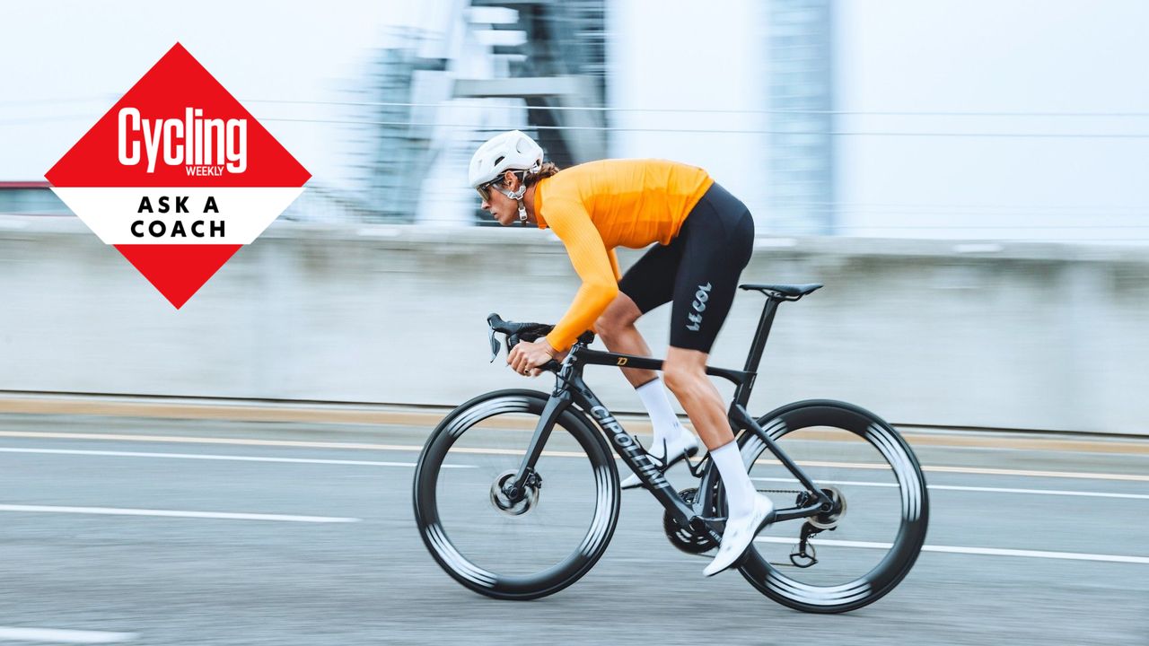 A man cycling in an orange jersey