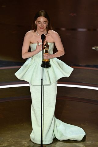 Emma Stone accepts the Oscar for Best Actress