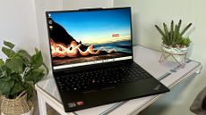 Lenovo ThinkPad E16 showing desktop on a table. 