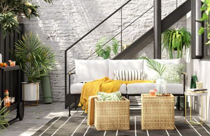 An affordable modern outdoor sofa on a paved patio