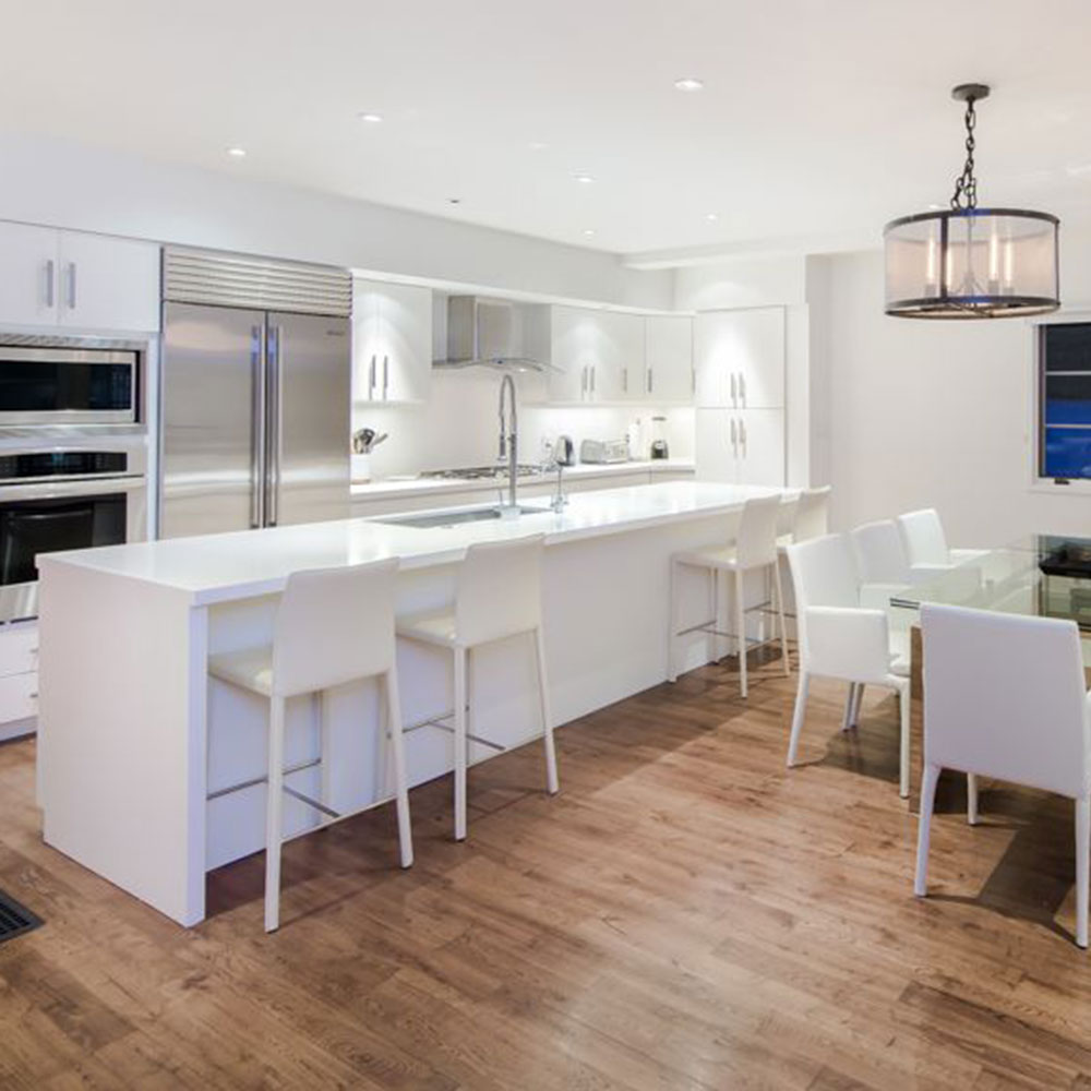 room with wooden floor and white counter and chairs