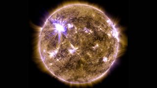 An X-class solar flare flashes on the edge of the sun on March 7, 2012 in this ultraviolet view from NASA's Solar Dynamics Observatory.