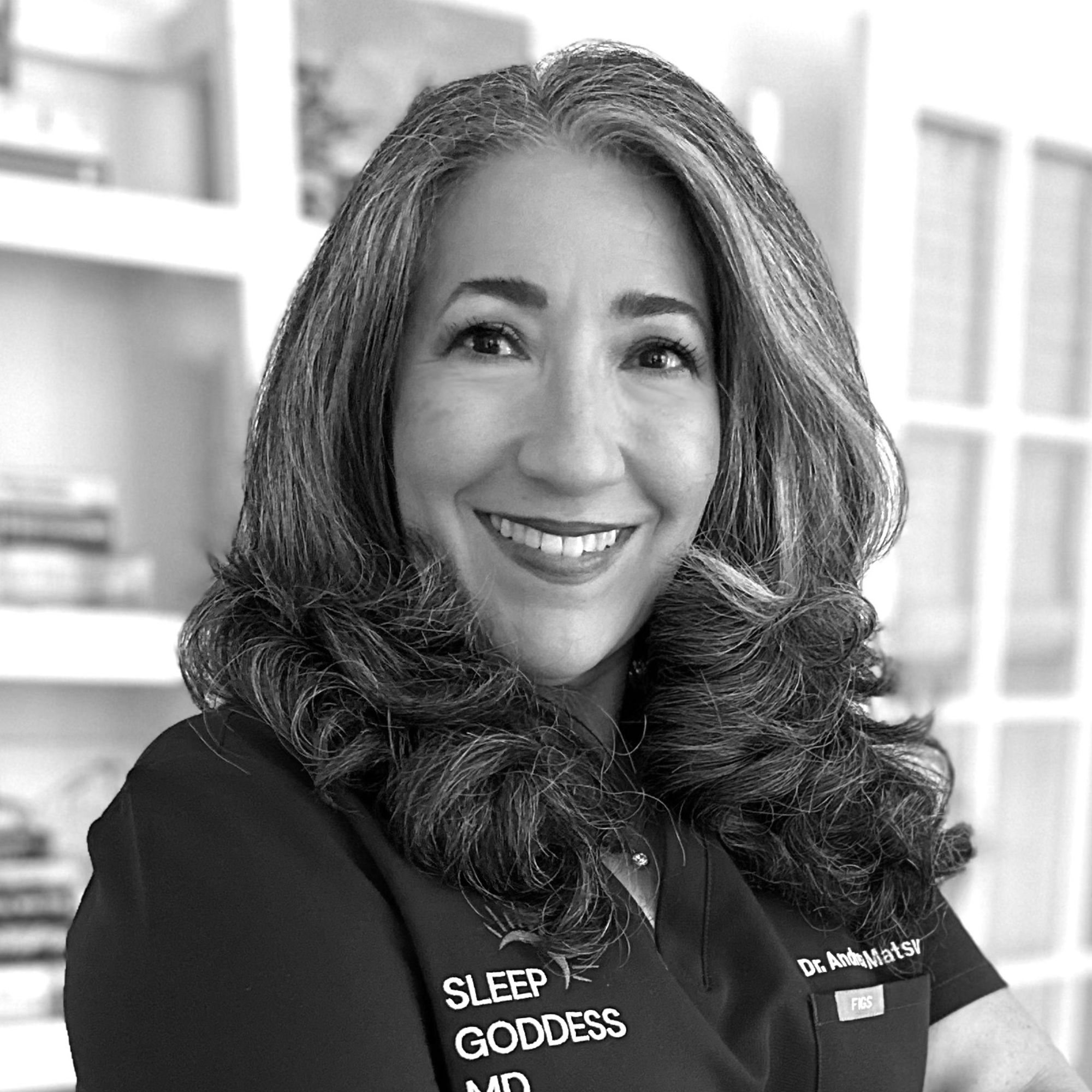 A black and white headshot of Dr. Andrea Matsumara