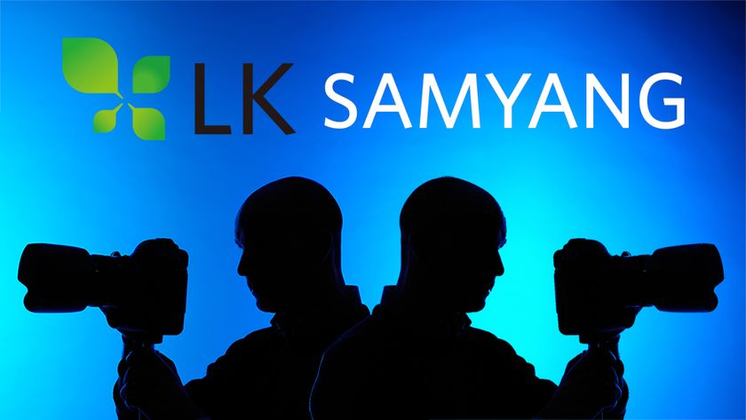 Silhouette of a mirrored photographer using a 300mm lens, with the LK Samyang logo