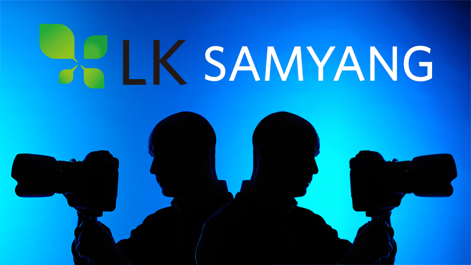 Silhouette of a mirrored photographer using a 300mm lens, with the LK Samyang logo