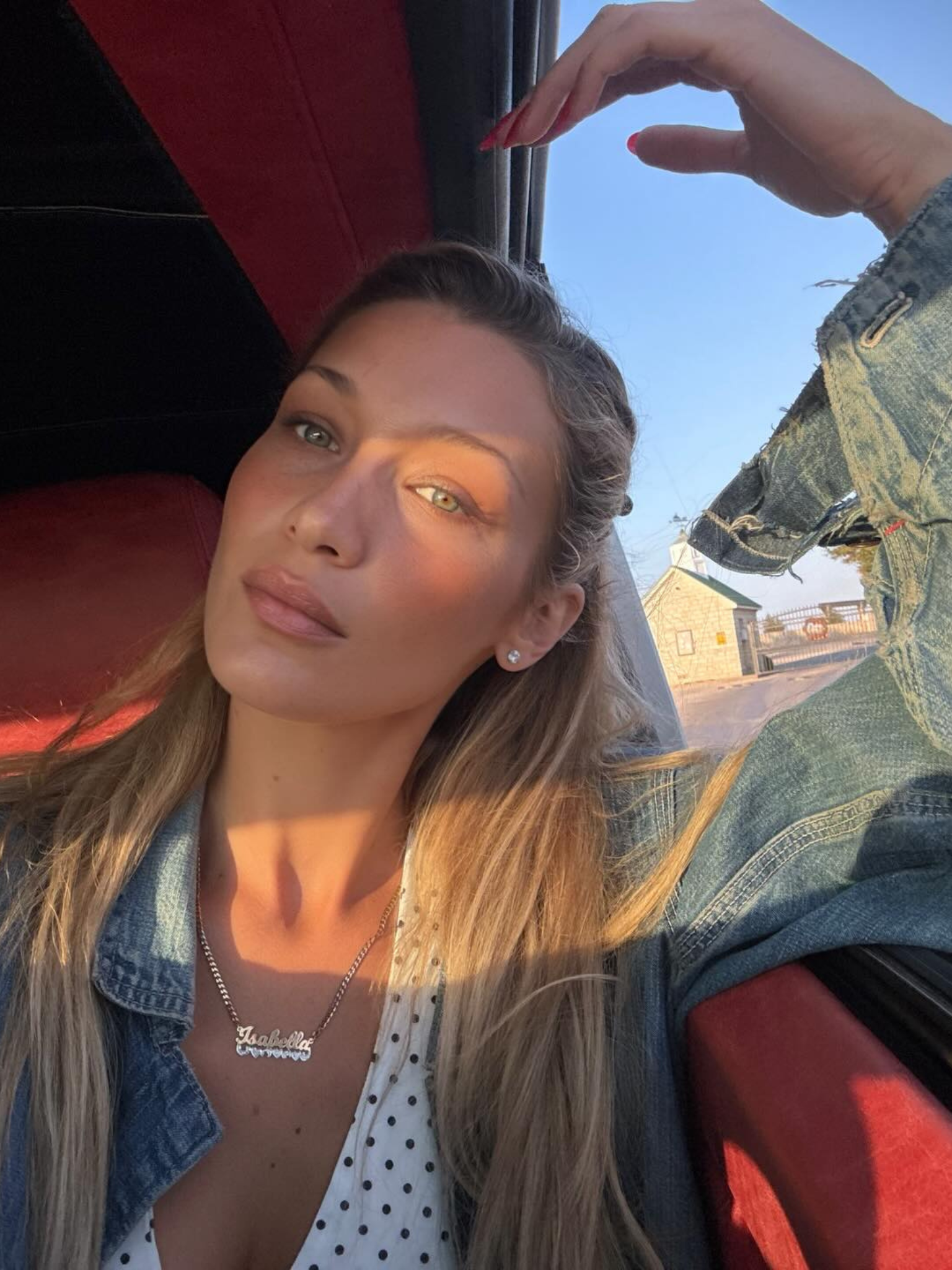 Bella Hadid taking a selfie in the sun with blonde hair