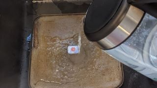 Pouring hot water into baking tray