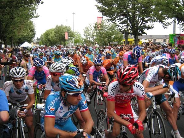 The peloton gathers at the start in Rodez under cloudy skies