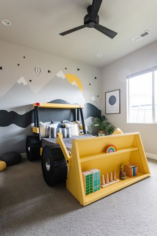 A bedroom with a bed designed like a tractor