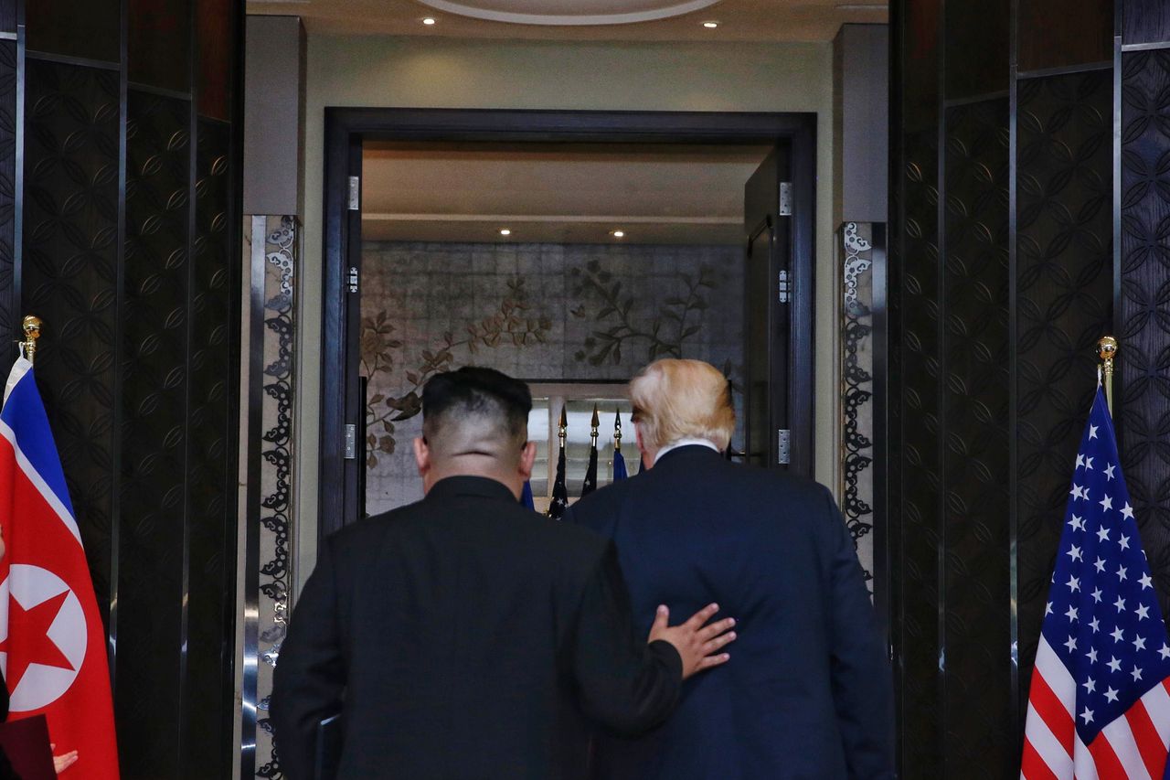 Kim places his hand on Trump&amp;#039;s back