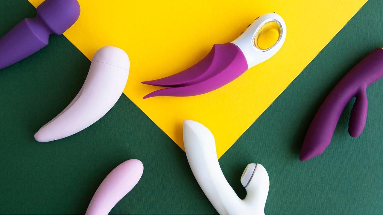 Collection of different types of sex toys on a green and yellow background. Sex toys for adults, dildos, vibrators, clitoral stimulators.