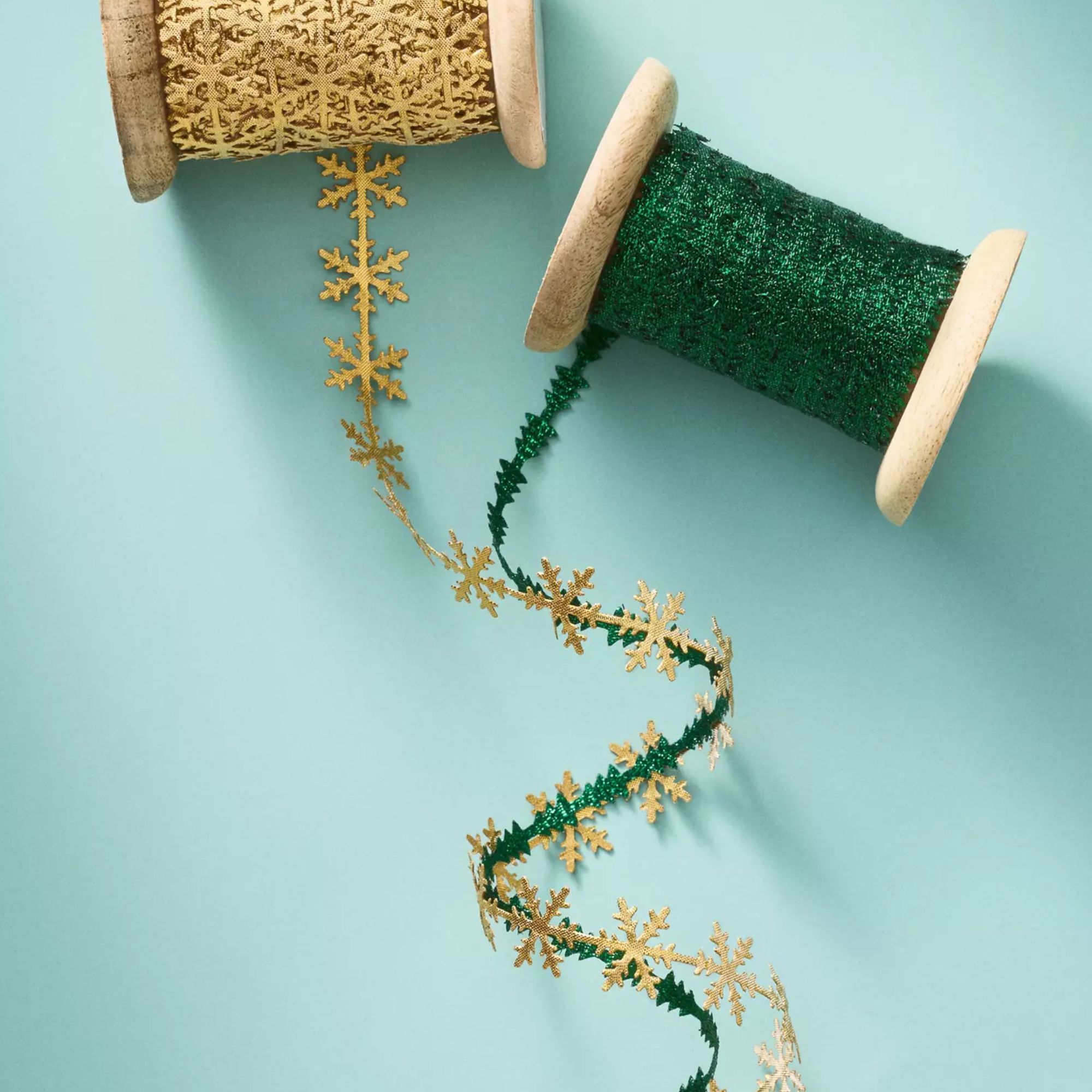 Rolls of green and gold metallic ribbon