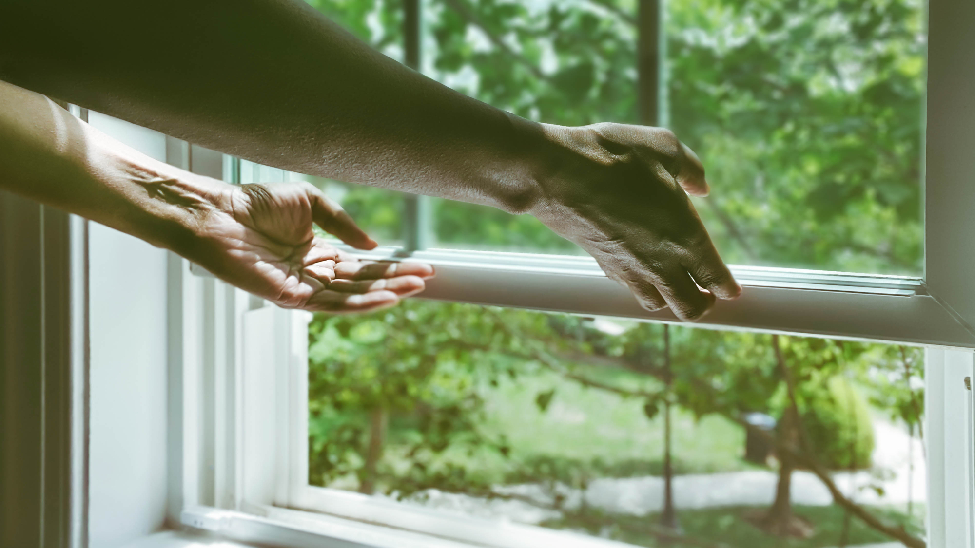 hands opening sash window