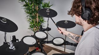 Man plays Yamaha DTX6 series electronic drum kit