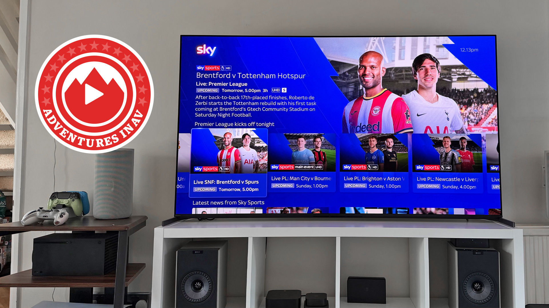 A photo of the 65-inch Sony Bravia 8 II in a living room. On the screen is a promo image for Sky's Premier League coverage and in the corner of the photo is a red logo that says 'Adventures In AV'