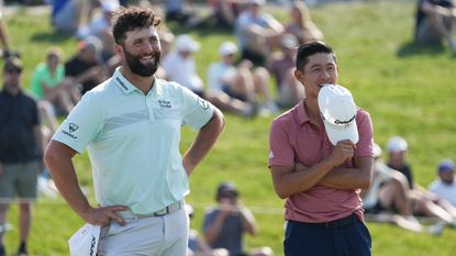 Jon Rahm of Spain and Collin Morikawa of the United States react on the 18th green during the second round of the Memorial Tournament 