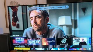 A TV showing the home screen of the Apple TV app, showing a still of Halt and Catch Fire featuring Lee Pace as Joe MacMillan
