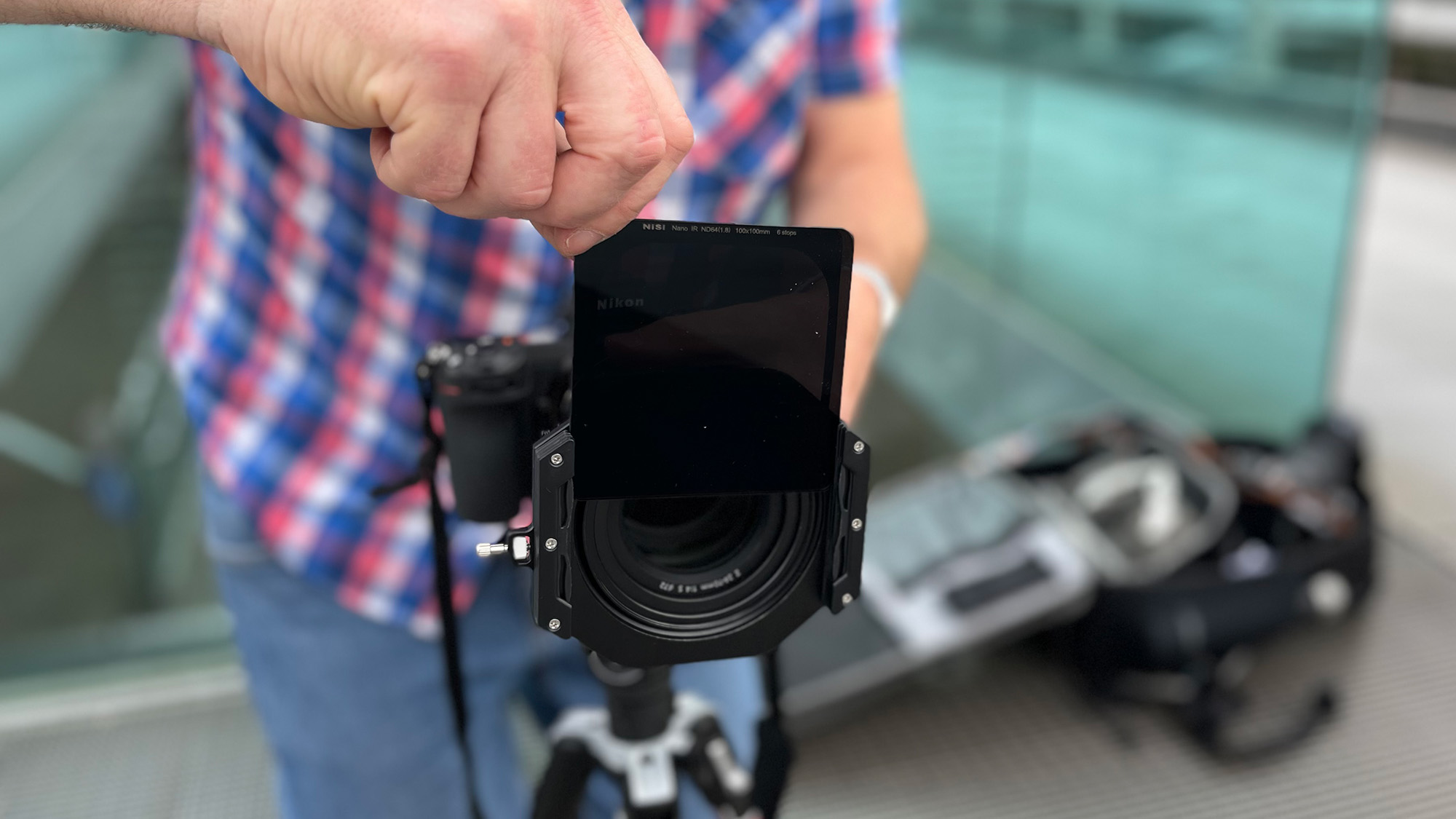 Adam Waring sliding an ND filter into a filter holder