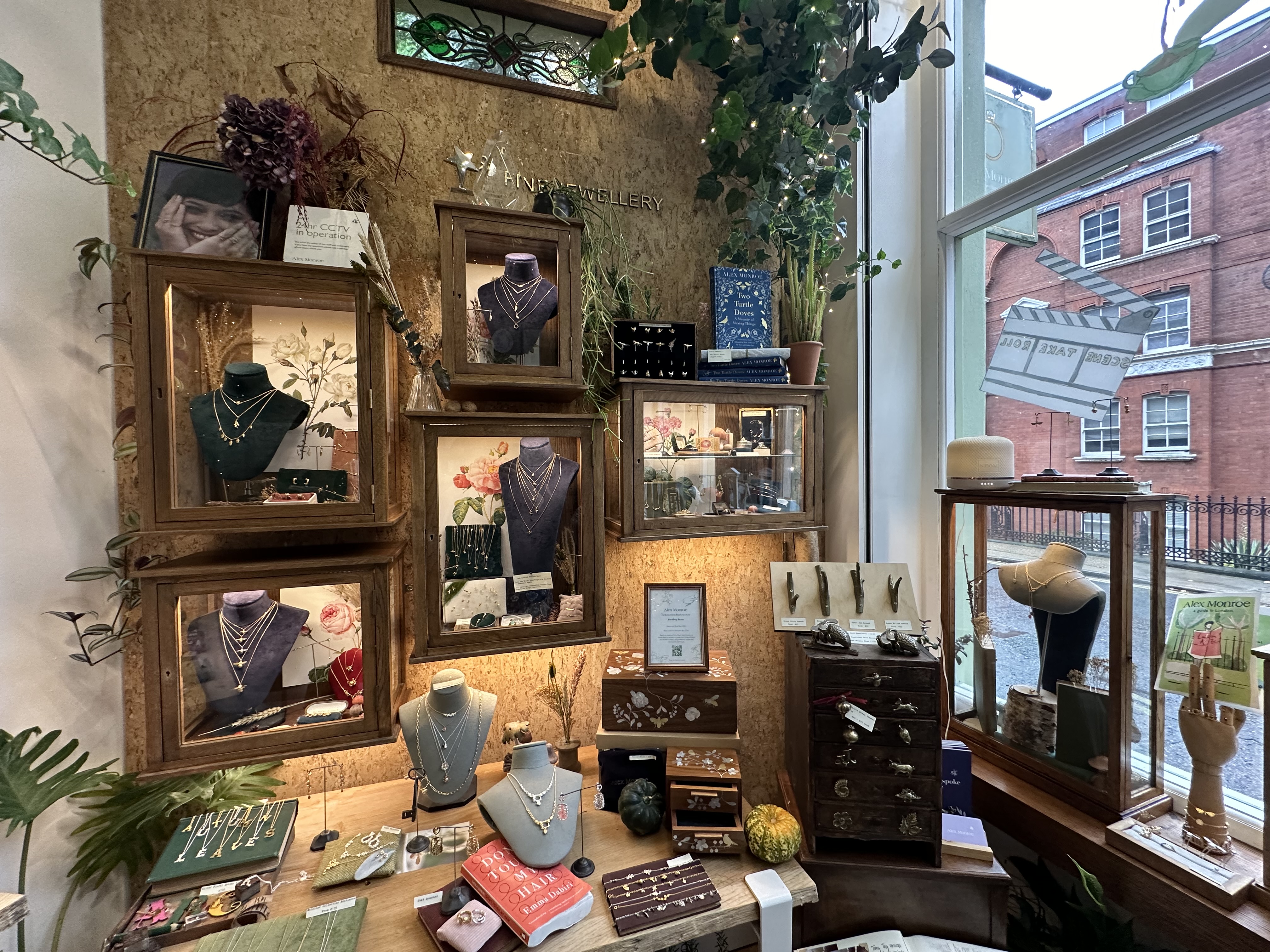 Display cases featuring necklaces inside Alex Monroe's jewelry store in London