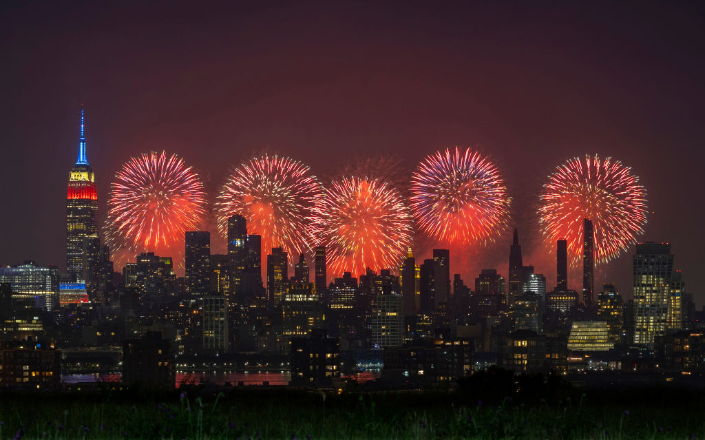 Macy's 4th of July fireworks light up the sky next to the Empire State Building in New York City on July 4, 2023, as seen from Union City, New Jersey.