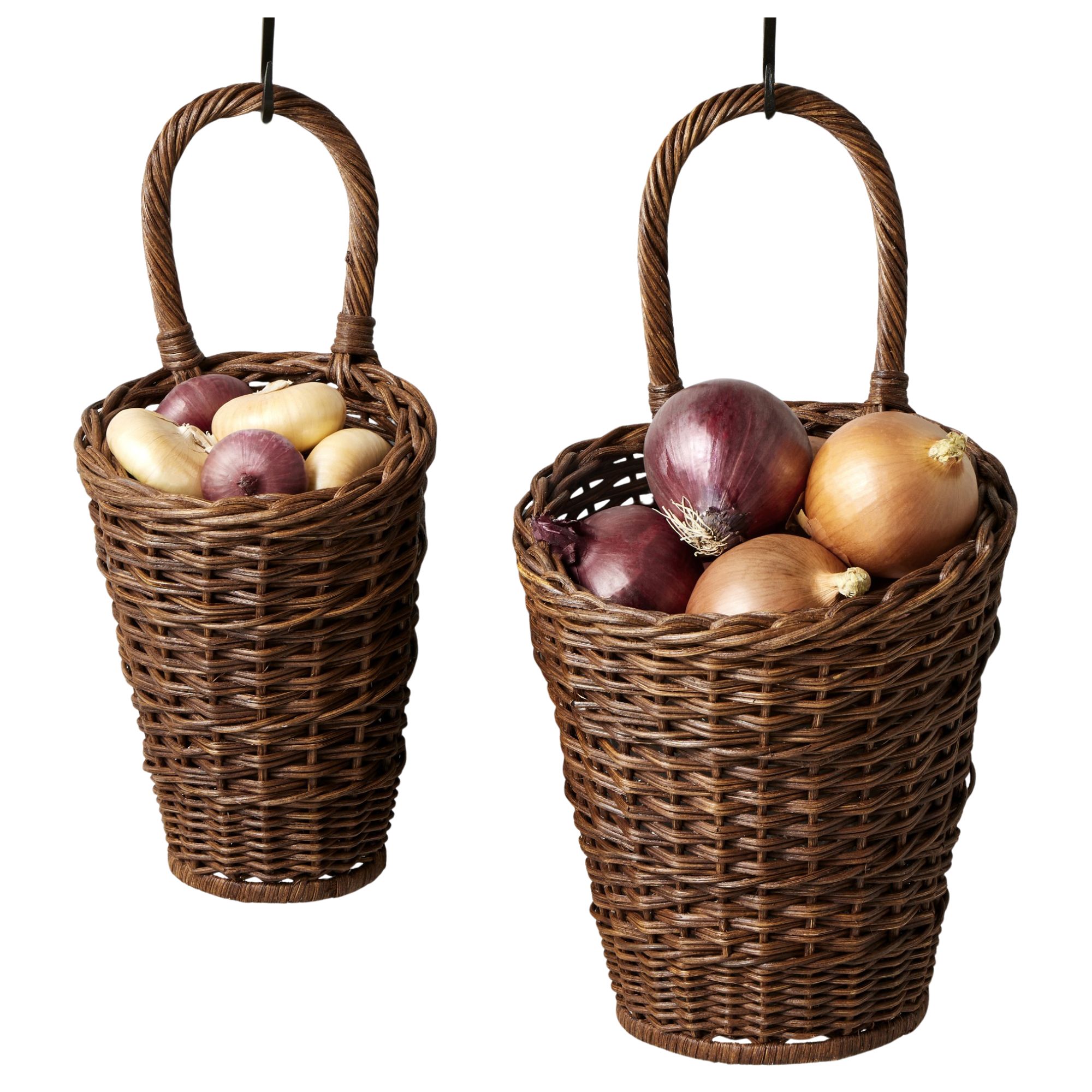 two handwoven rattan food baskets for the kitchen, pictured with potatoes and onion inside. They have handles and a hook is visible at the top