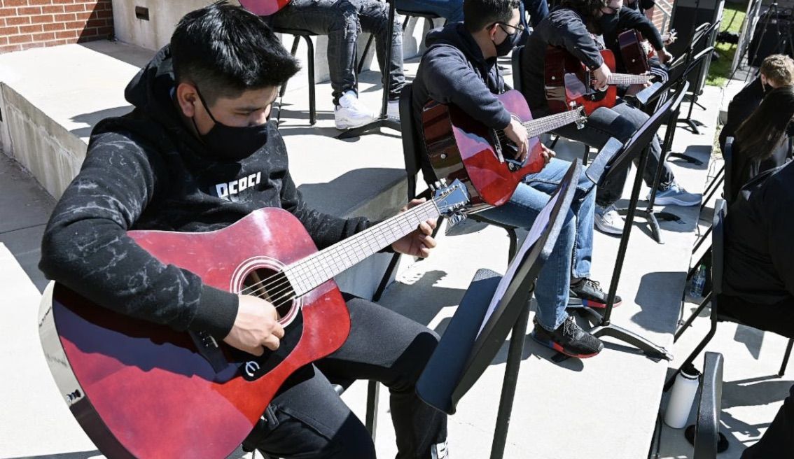 A John Overton High School student in Nashville plays an Epiphone acoustic guitar donated by Gibson