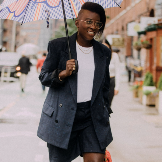 nikki ogunnaike wearing a blazer, a t-shirt, and shorts