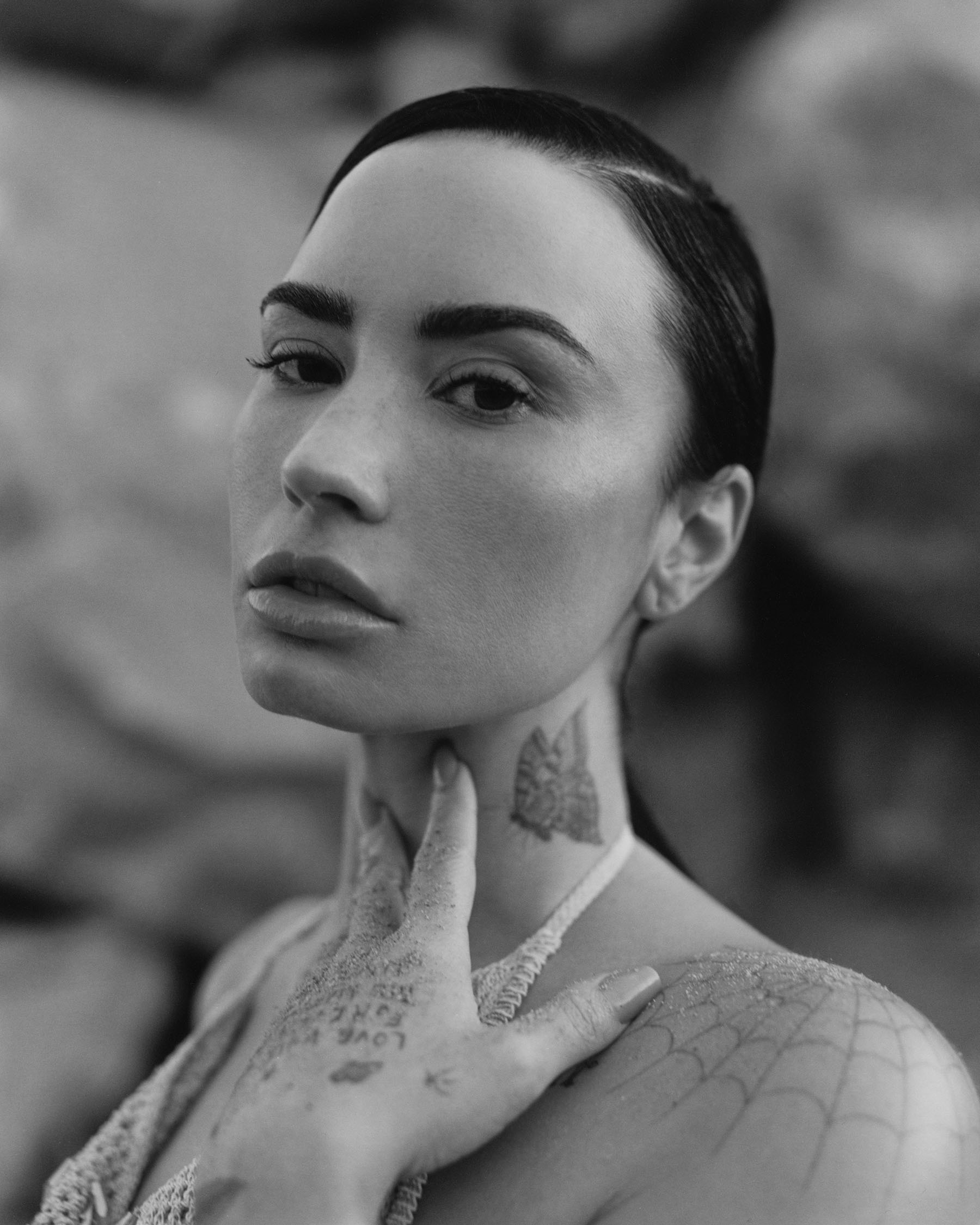 Demi Lovato forBest Knockoff Luxury Clothing
&#039;s November cover. It is a black and white portrait shot of Lovato with her hand resting on her neck.