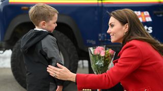 Kate Middleton receives flowers from a young boy