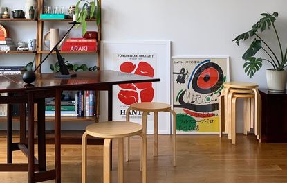 A living room with stackable stools used as a side table