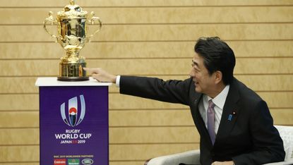 Japan’s Prime Minister Shinzo Abe is pictured with the Webb Ellis Cup 