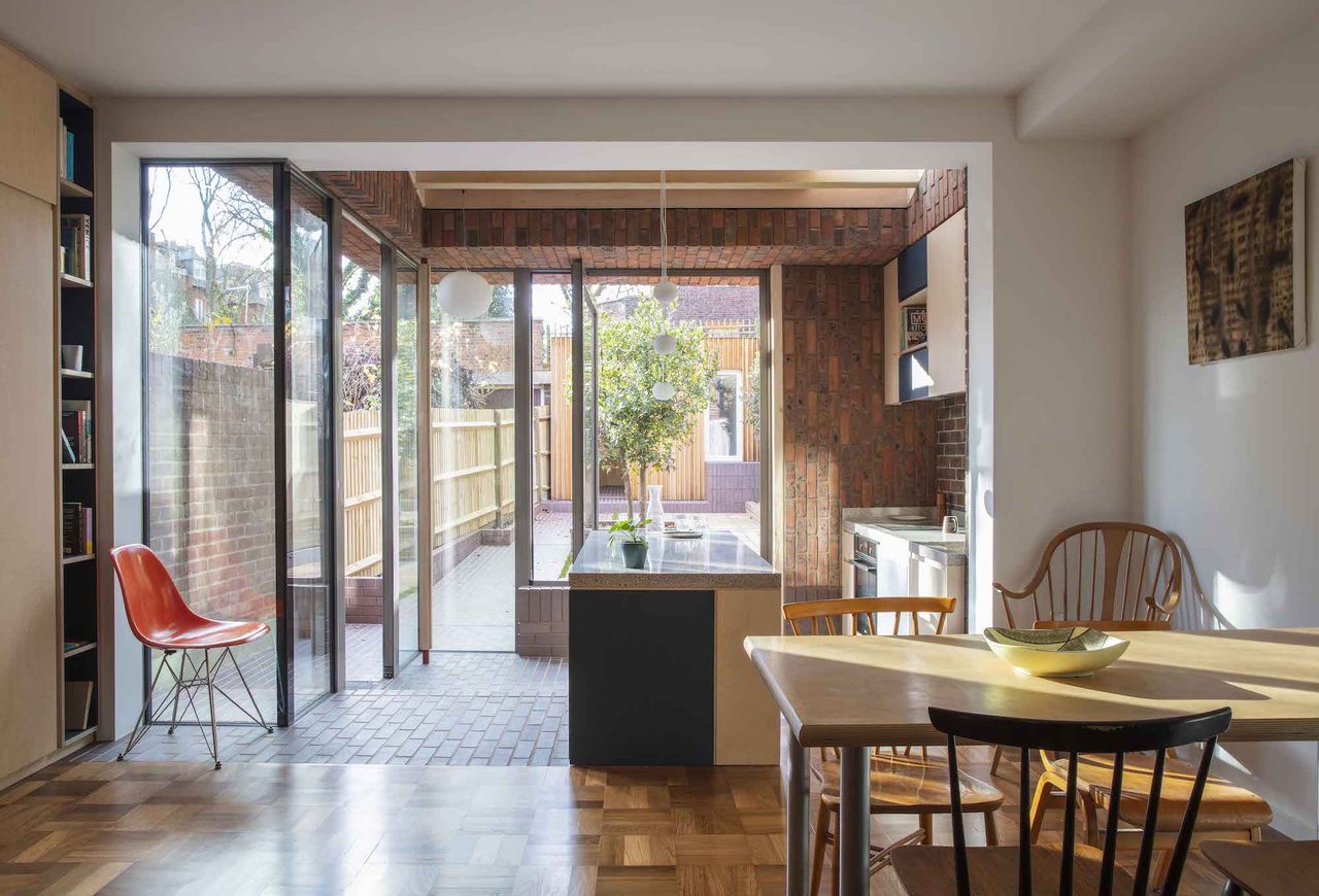 interior kitchen diner extension space with wood floor and brick detailing