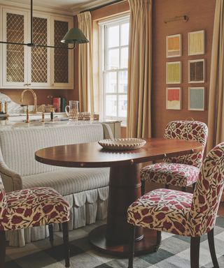 dining banquette in kitchen with upholstered sofa and chairs around oval shaped table