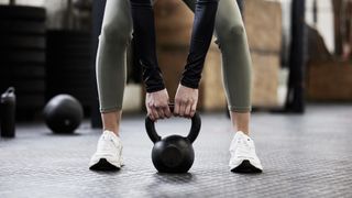 woman lifting kettle bell
