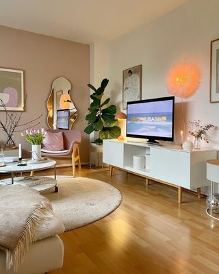 Living room with white rug and TV stand