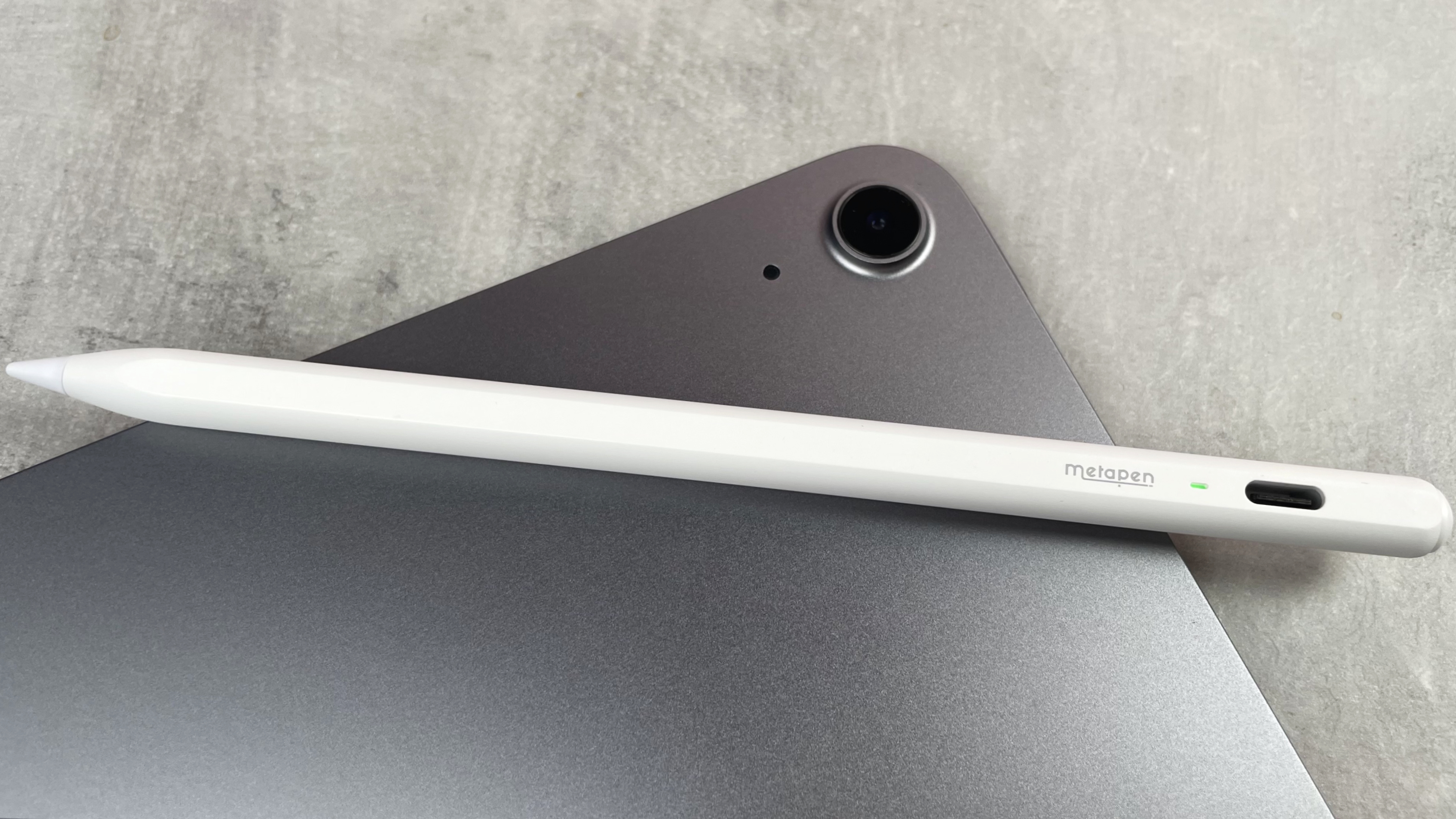 The Metapen Pencil Air8 is pictured lying across the back of an iPad.