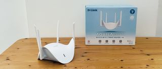 D-Link Aquila Pro AI R95 on wooden table