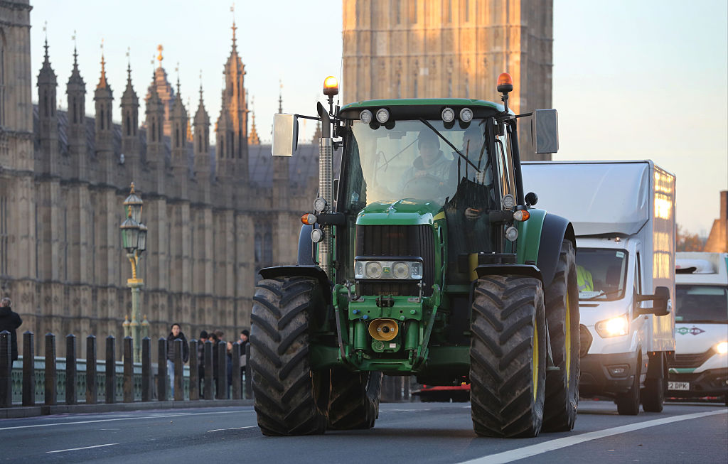 A tractor crosses Westminster Bridge during the protest against reforms to inheritance tax relief on agricultural property on November 26, 2025 in London, England