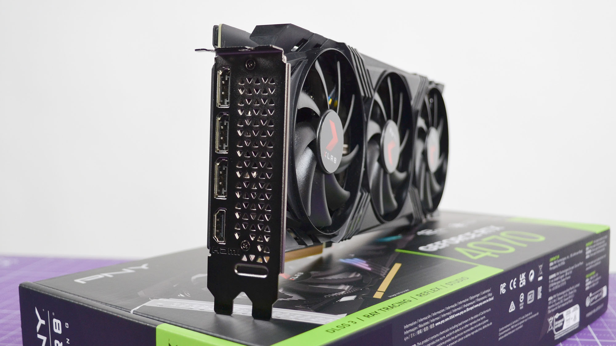 A PNY GeForce RTX 4070 XLR8 OC graphics card on a purple desk mat